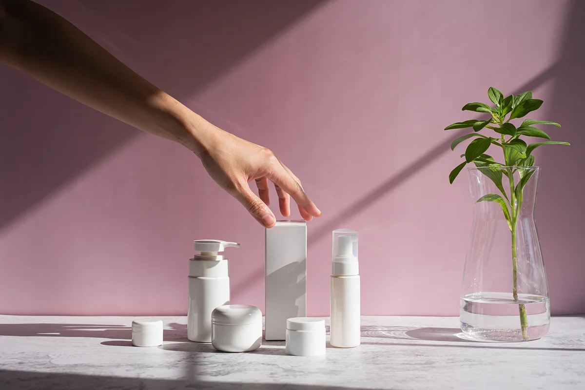 Hand is touching skincare set