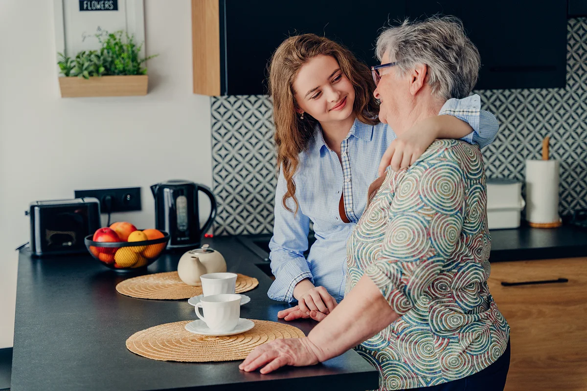 grandmother and teen granddaughter laughing and talking