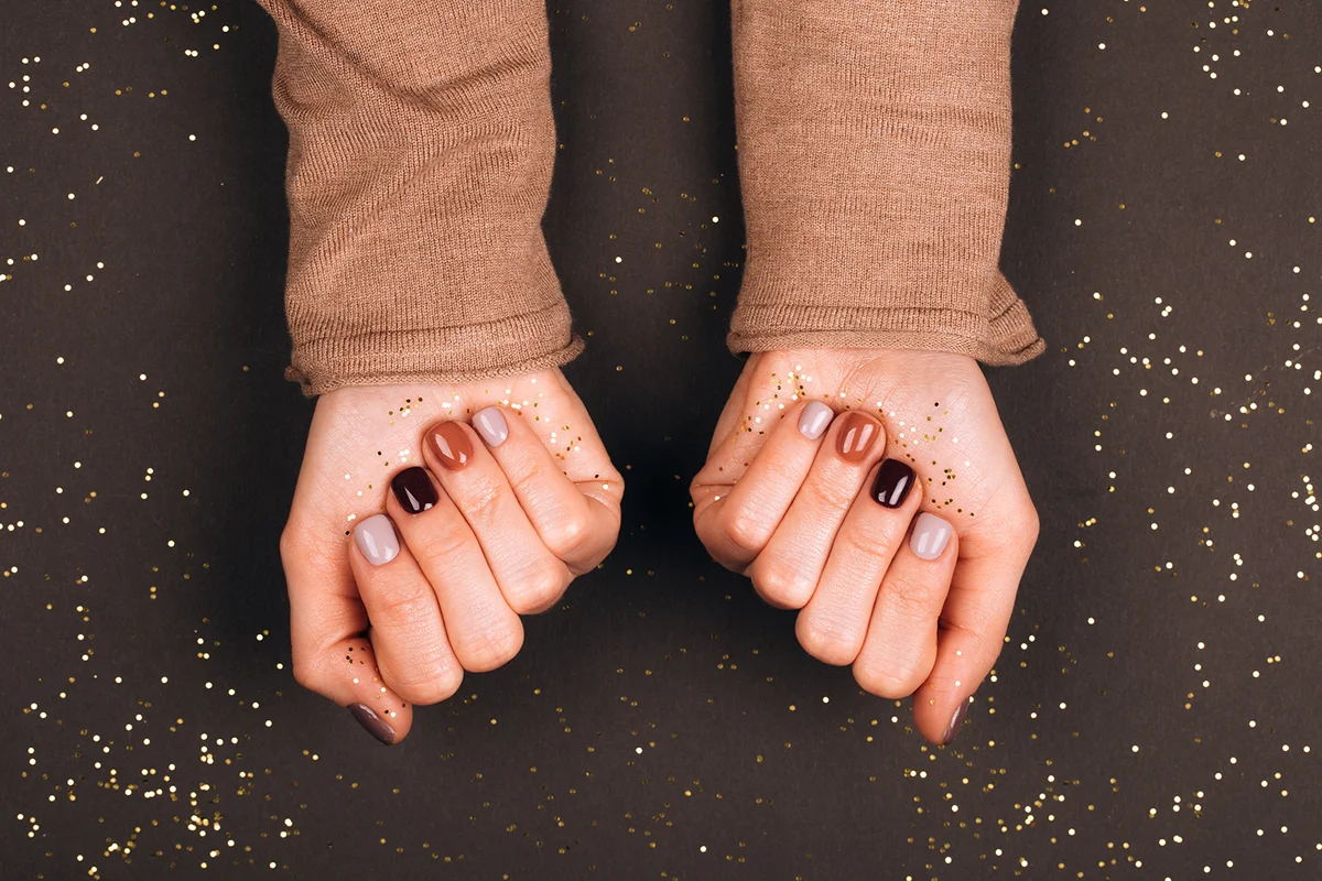 Stylish two-tone nail art in earthy brown shades, perfect for fashion enthusiasts