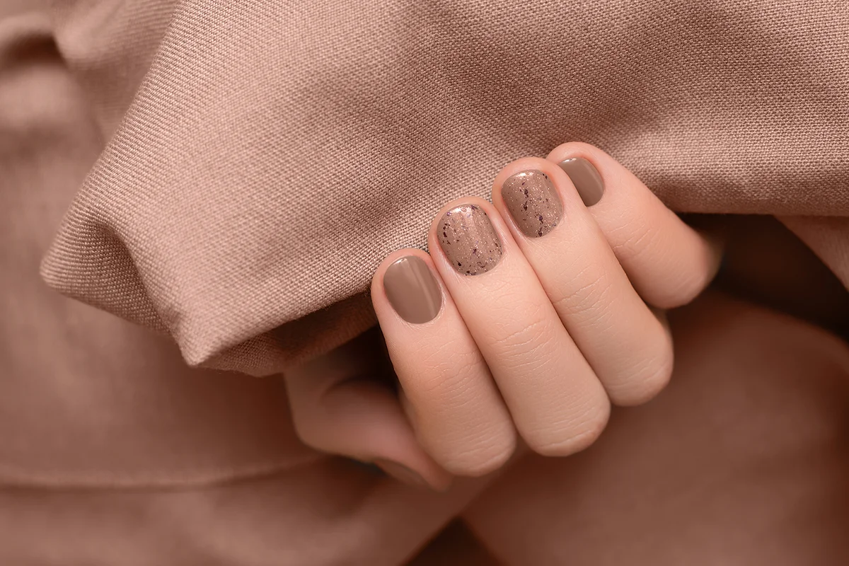 Female hand with brown nail design