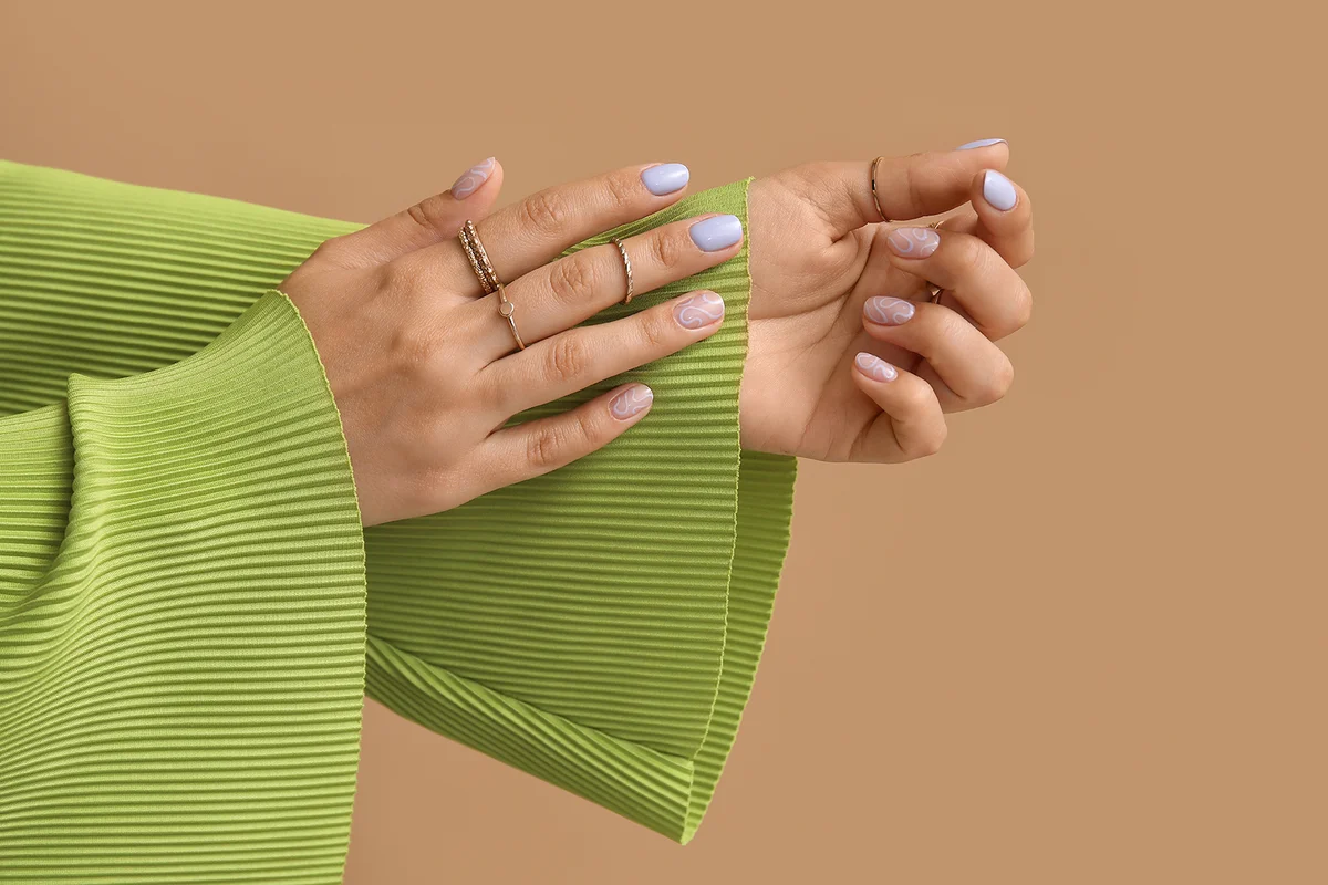 Female hands with beautiful manicure against color background