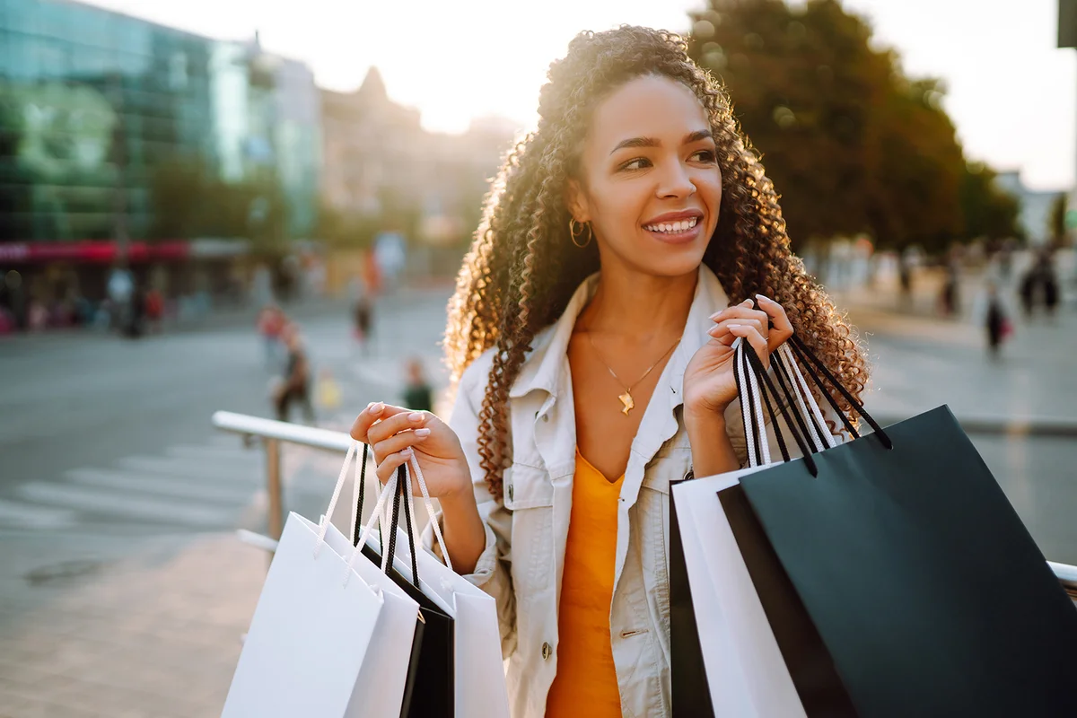 Fashion woman with shopping bags walking on street