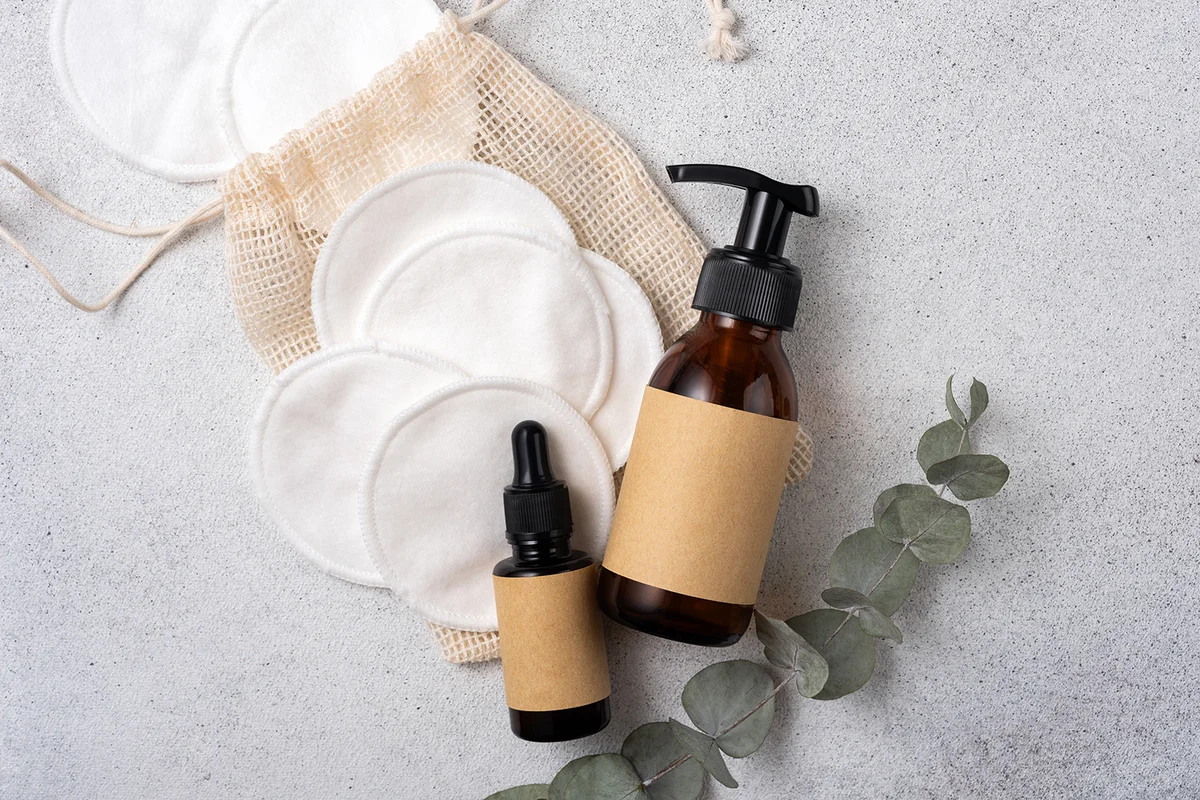 Reusable cotton pads for makeup removal and brown glass cosmetic bottles