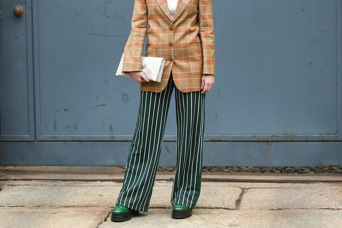 Street style outfit, fashionable woman wearing a brown orange green checkered oversized blazer jacket