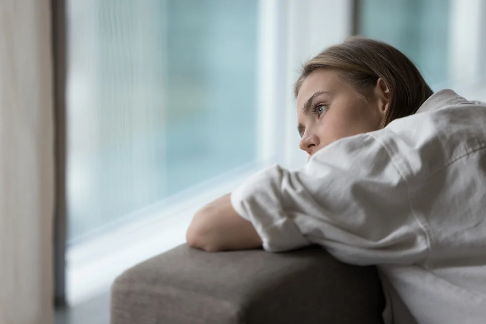 woman looking out the window