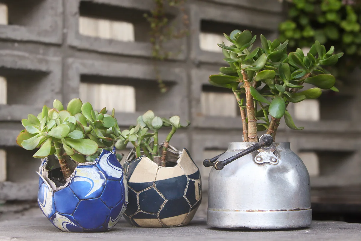 old soccer ball and teapot turn into garden flower pots
