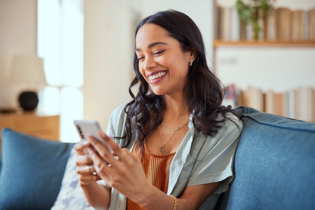 woman smiling at phone