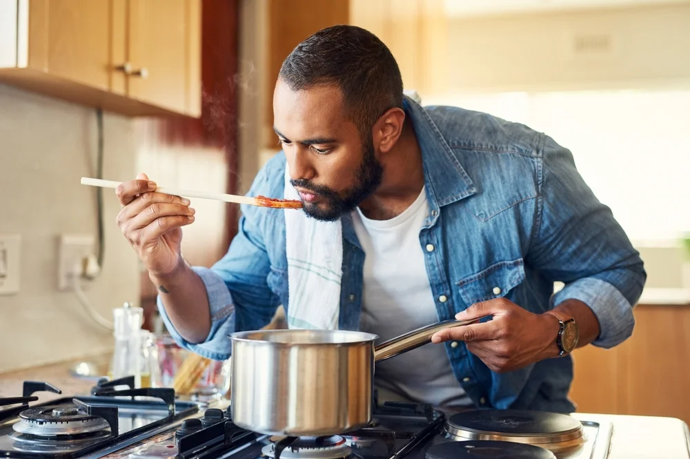 Man tasting sauce