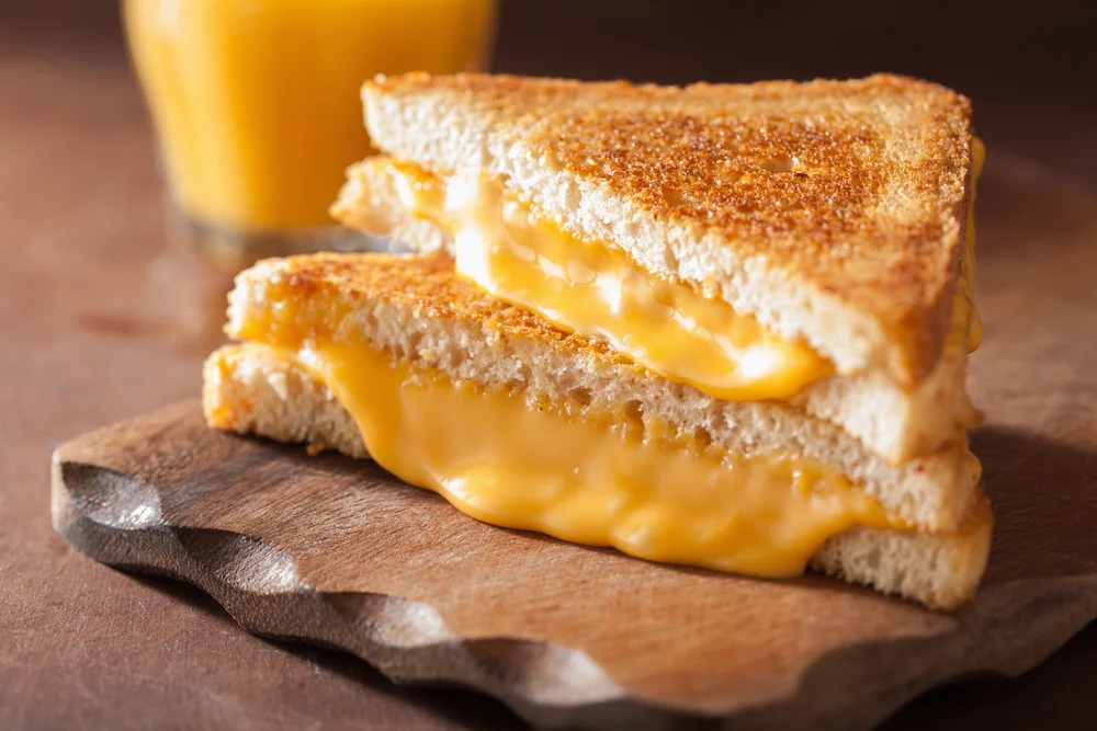 closeup of crunchy and gooey grilled cheese on a plate