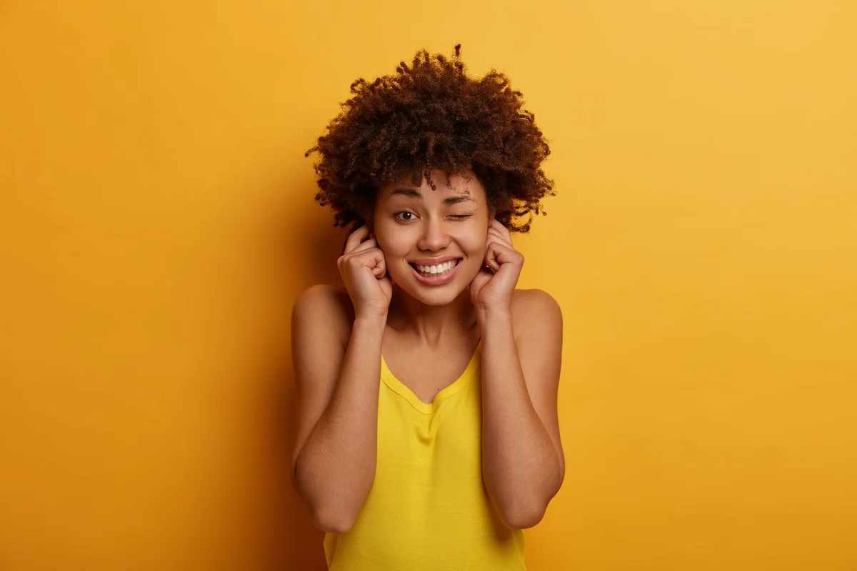 woman with ears plugged