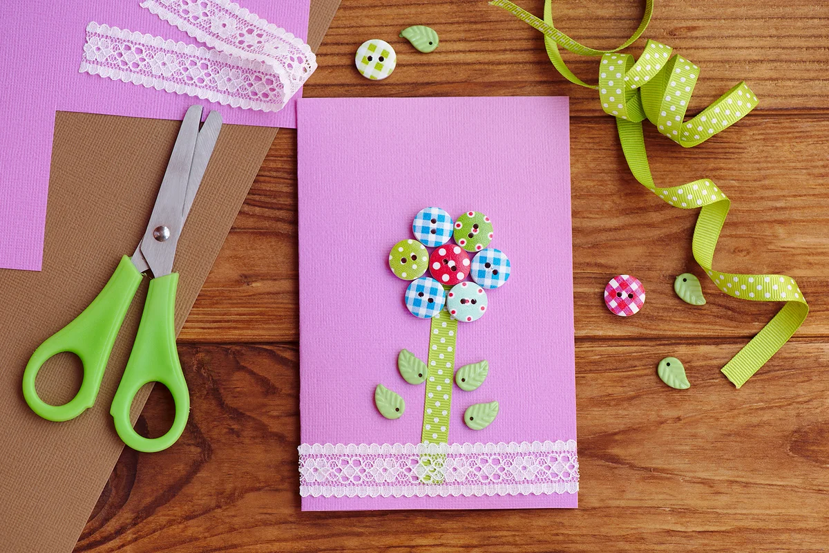 Greeting card with a flower made of wooden buttons