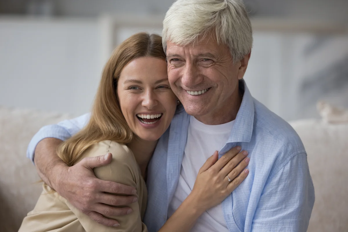 father and adult daughter laughing