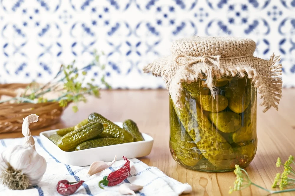 jar of homemade pickles covered with burlap