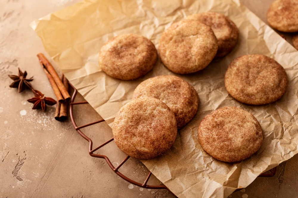 snickerdoodles cooling on a baking sheet