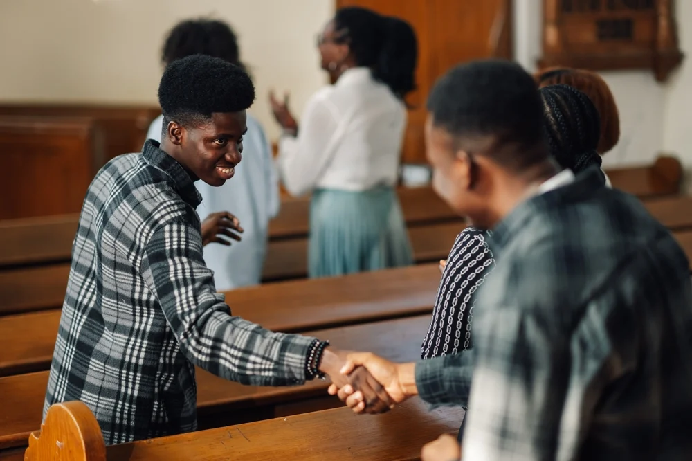 two men shaking hands at church