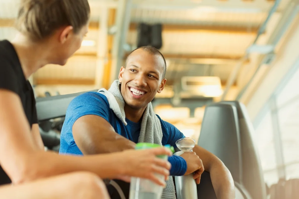 man and woman talking at the gym