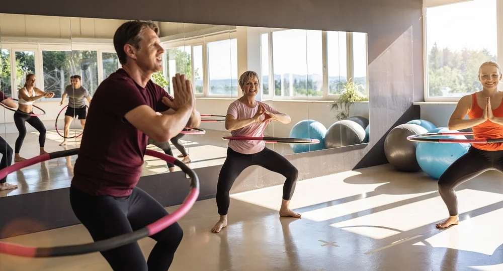 group of people in a hooping class