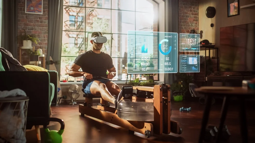 man on rowing machine with VR goggles
