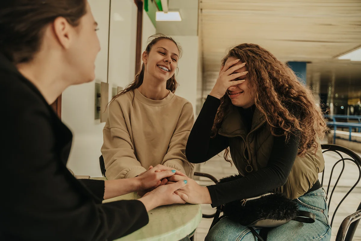 Curly haired girl slaps her forehead in oh-no moment.