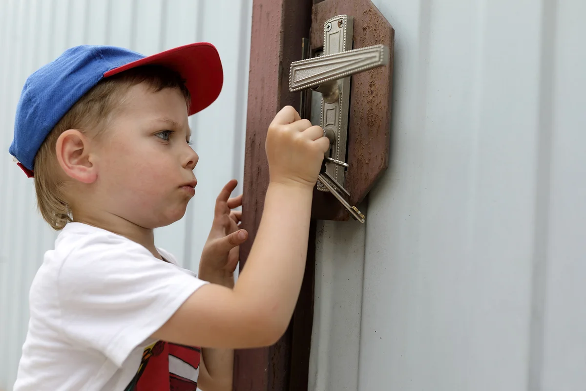 Child opening lock of a door with key