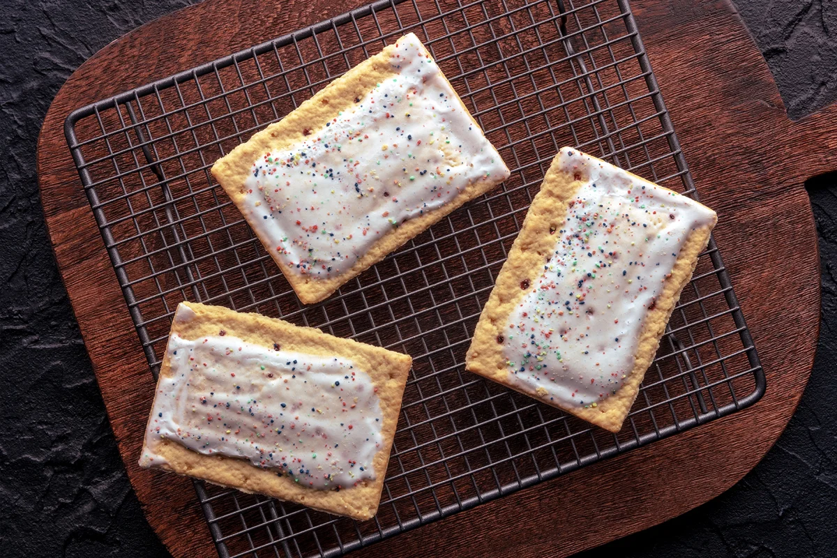 Poptart toaster pastry with icing on a wooden cutting board