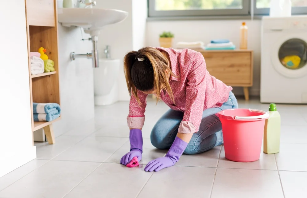 Tired woman scrubbing the floor
