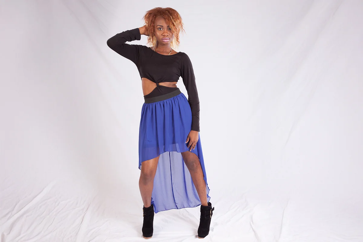Pretty black woman in a blue high/low him dress