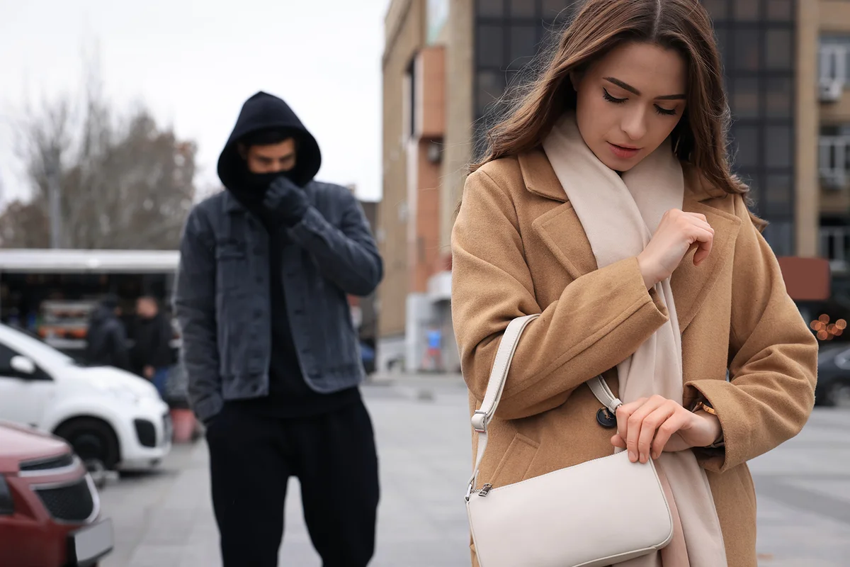 Man stalking young woman on city street