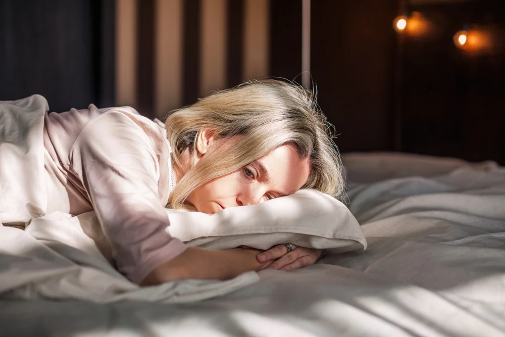 tired woman in bed