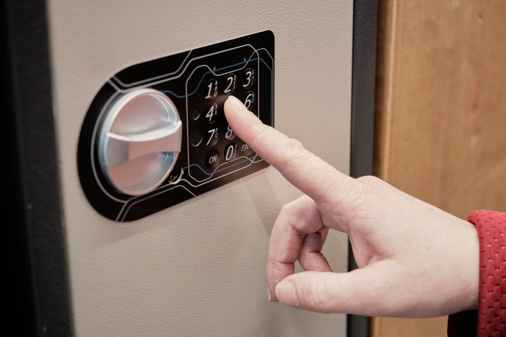 person entering a code on a safe