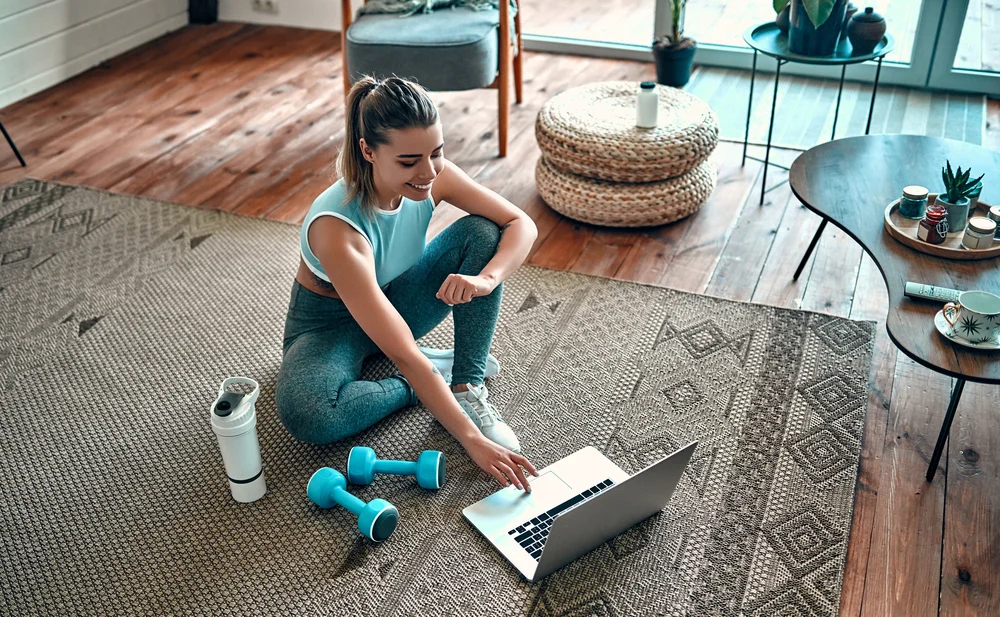 woman in workout wear on computer
