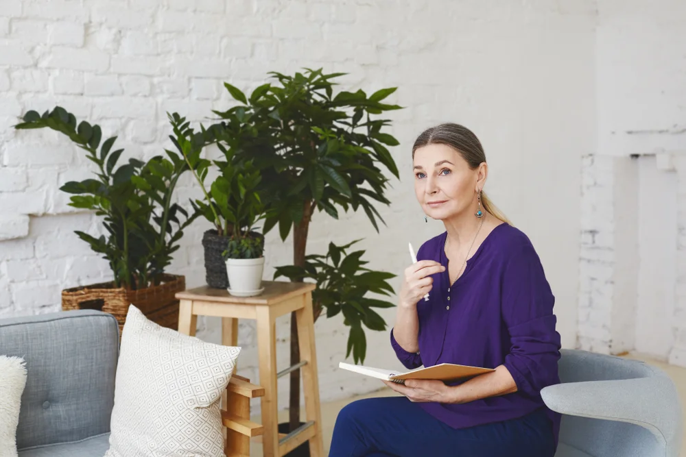 woman with notebook thinking