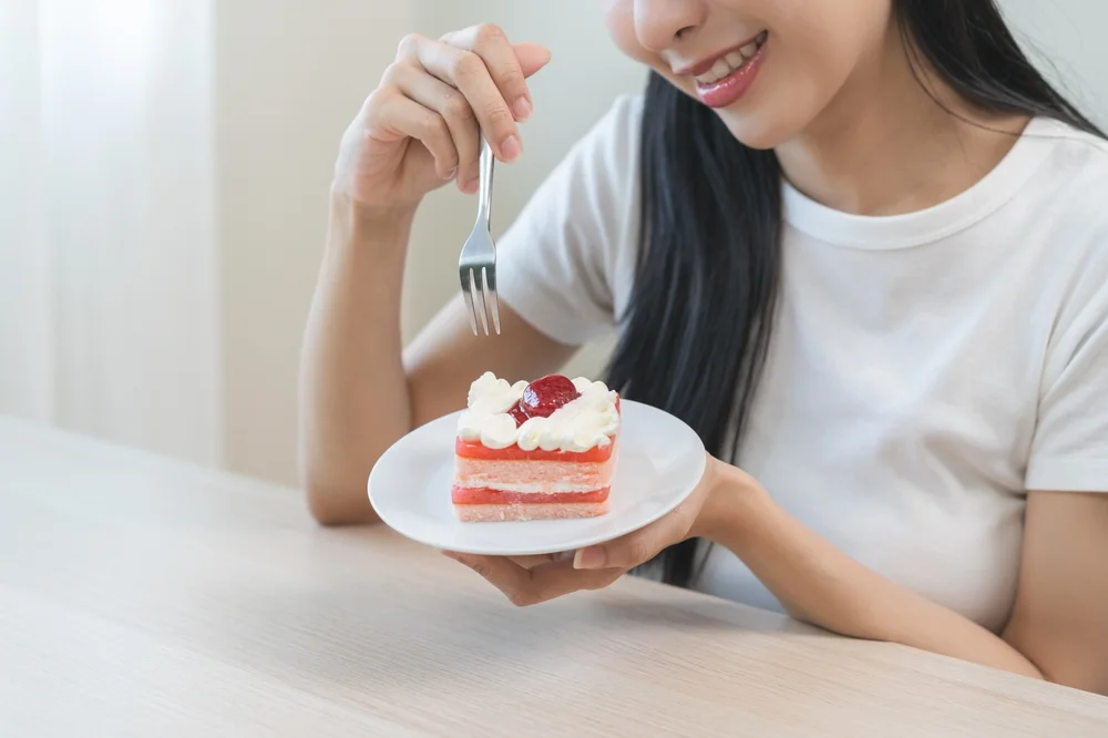 person eating cake