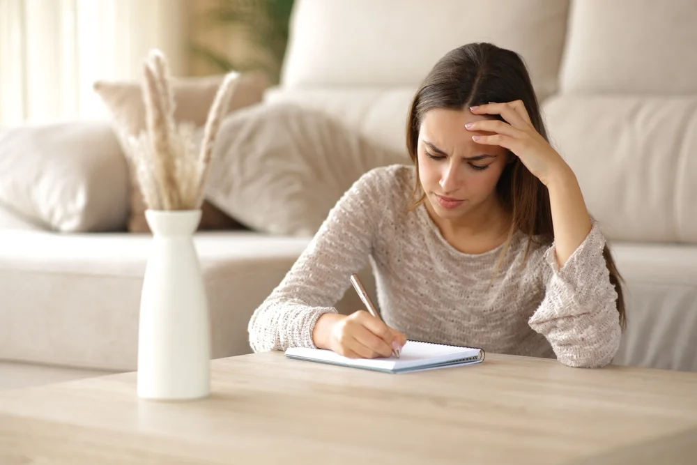woman writing in notebook