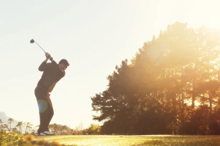 golfer hitting a tee shot