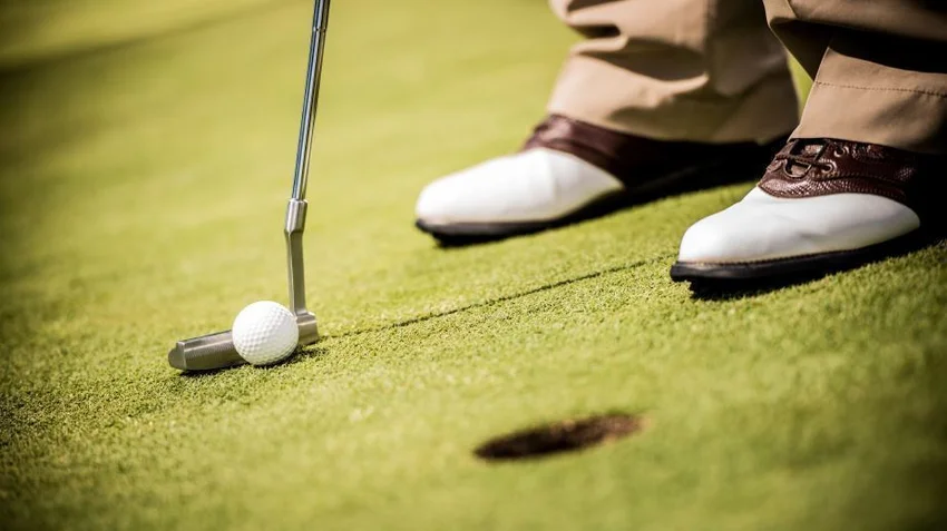 golfer with a tap in putt