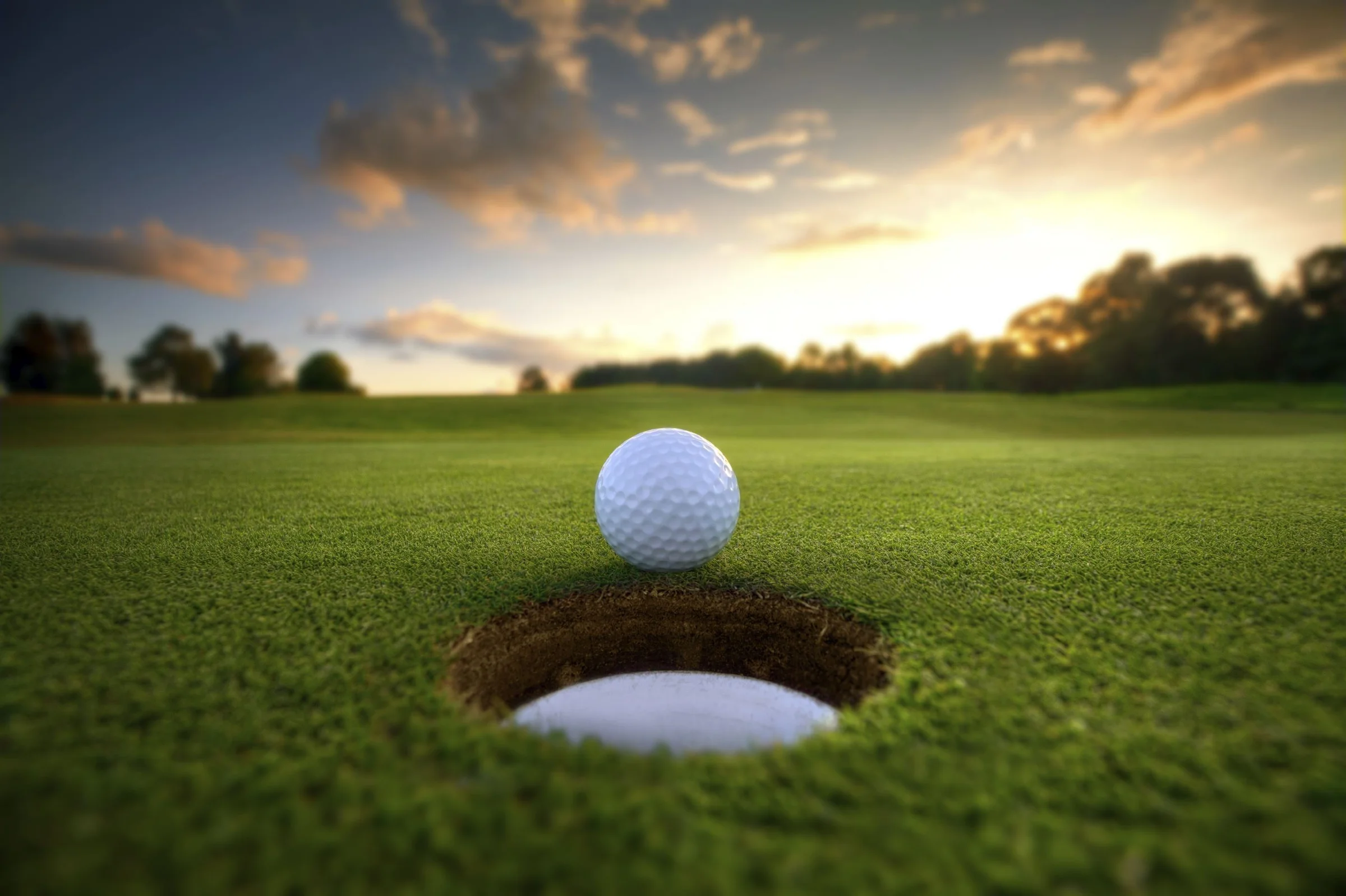 Golf ball on the edge of the hole