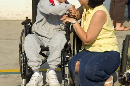 child in wheelchair and mother. source:istockphoto. permission:licensed.
