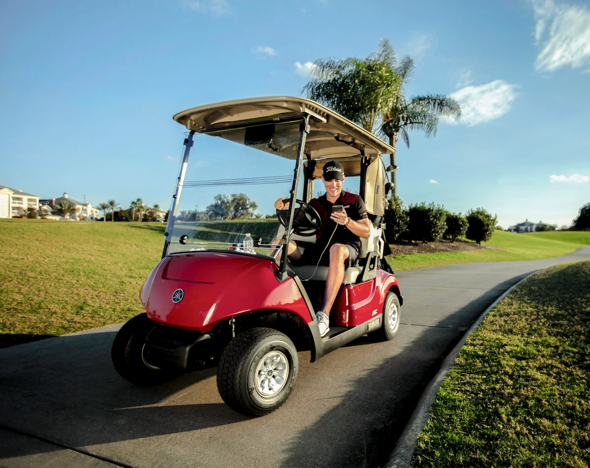 Man driving Yamaha golf cart