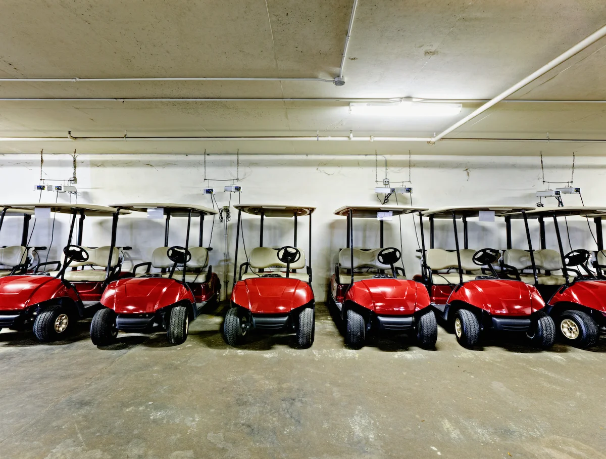 Red golf carts in garage