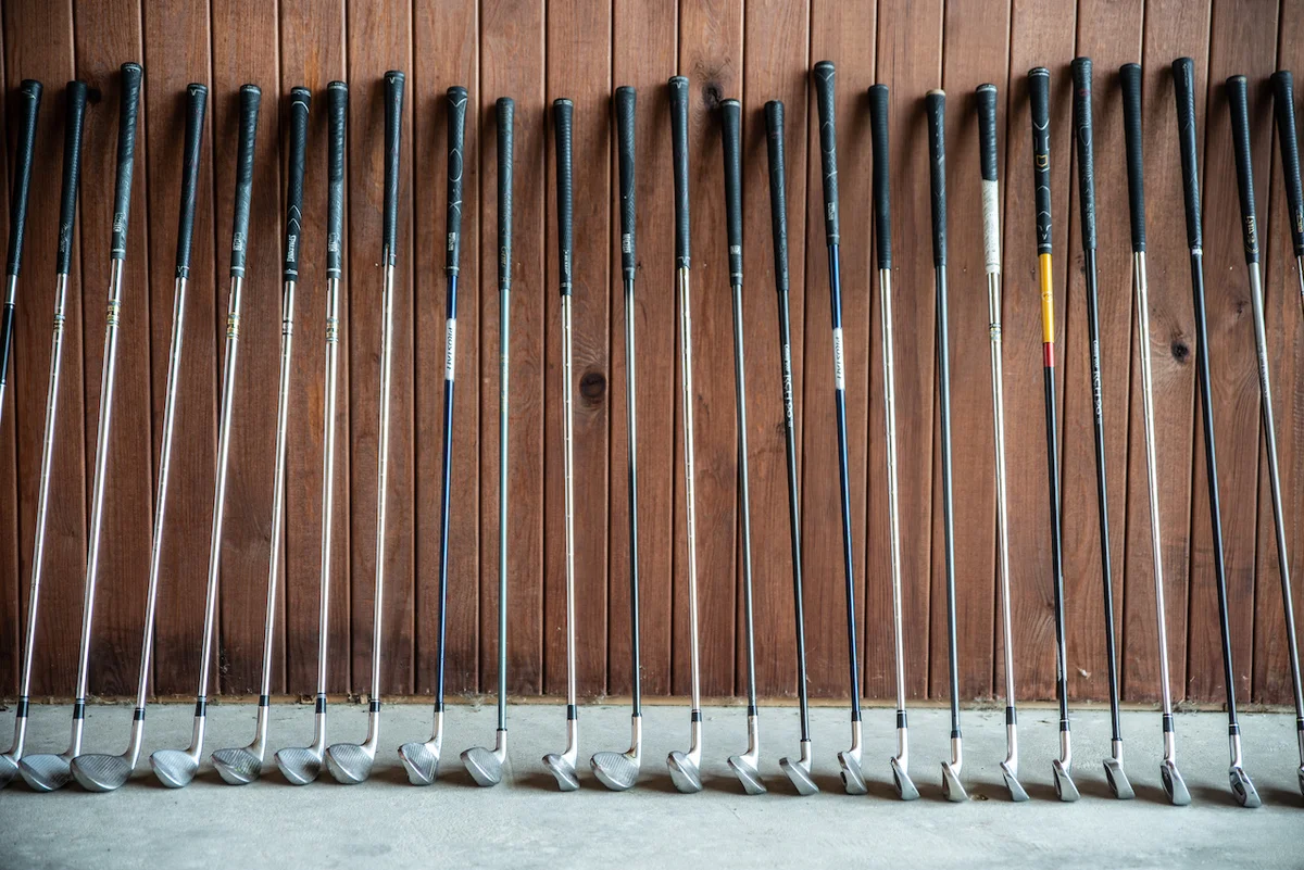golf clubs with wood background