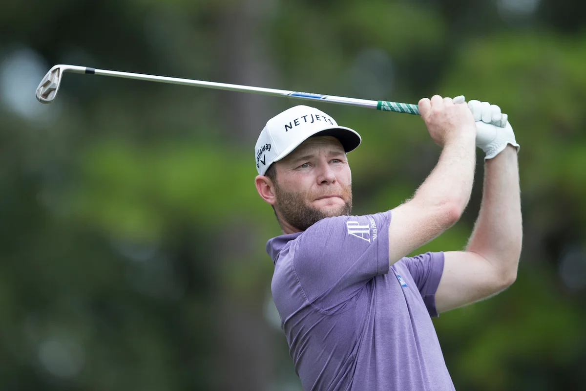 golfer using iron