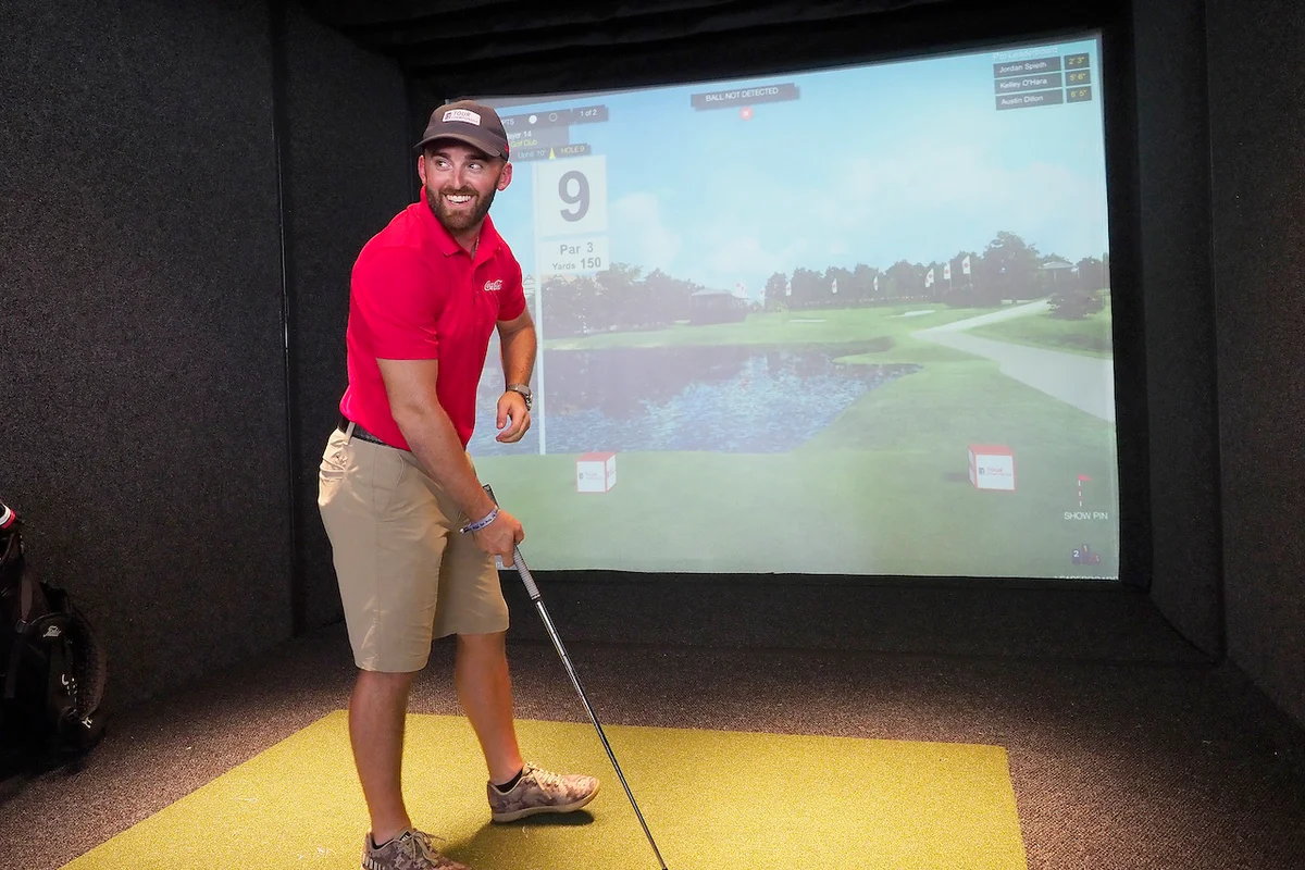 Golfer using simulator