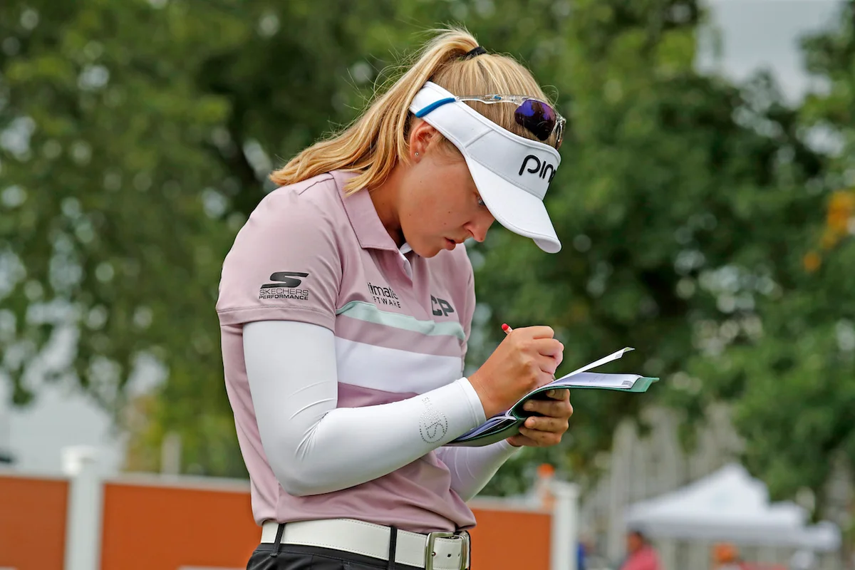 Golfer filling out scorecard