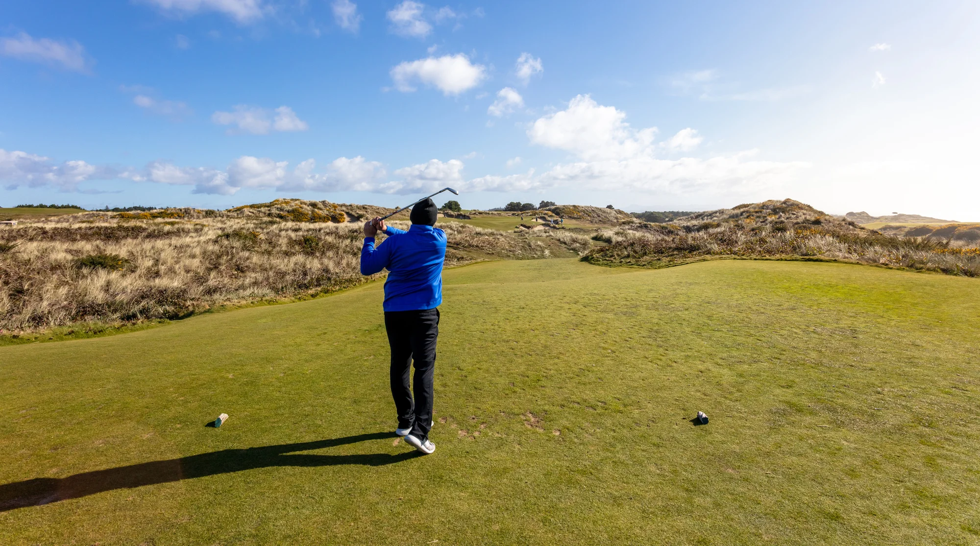 A golfer tees off in Bandon, Oregon