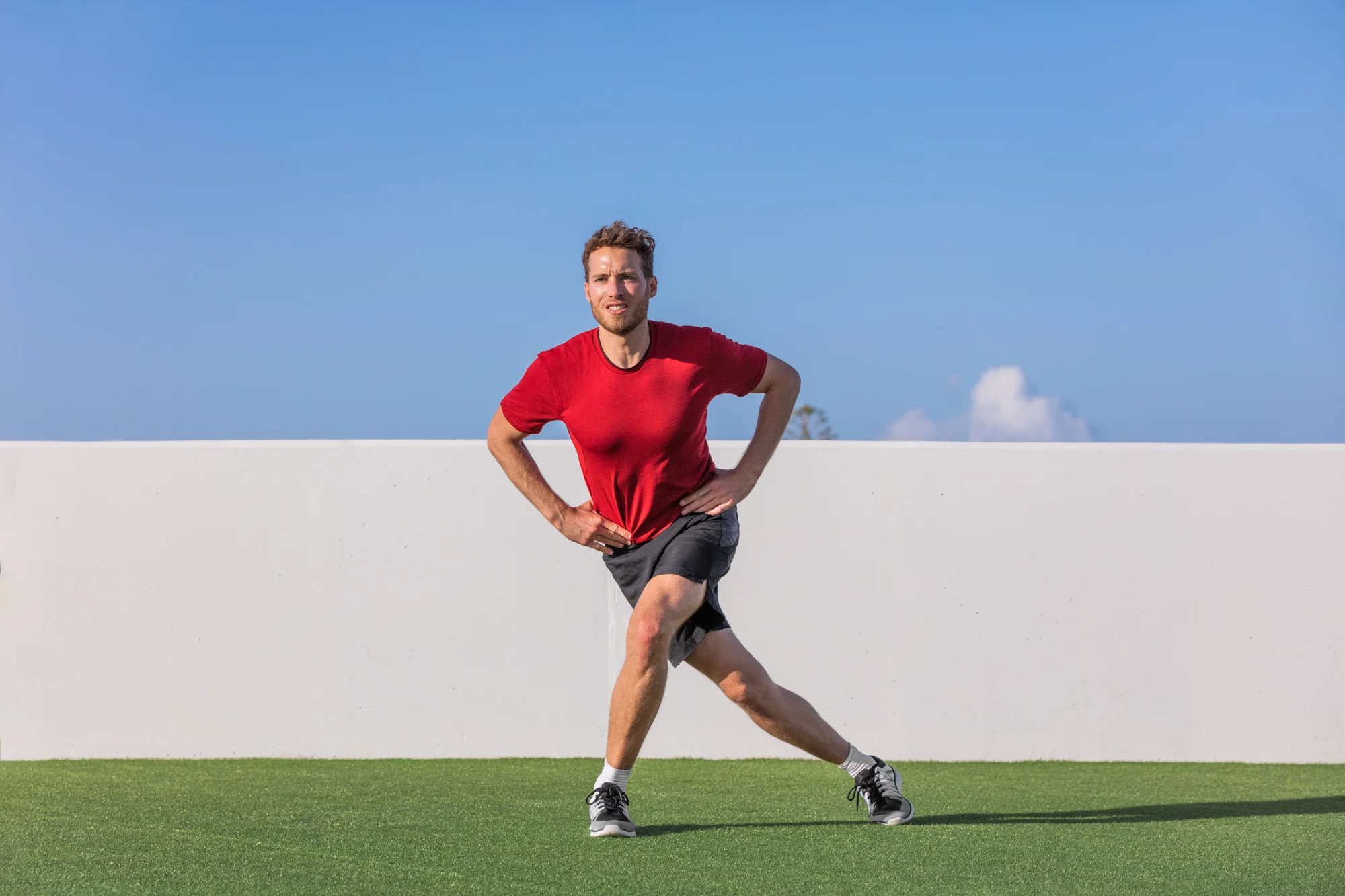 man doing curtsy lunge