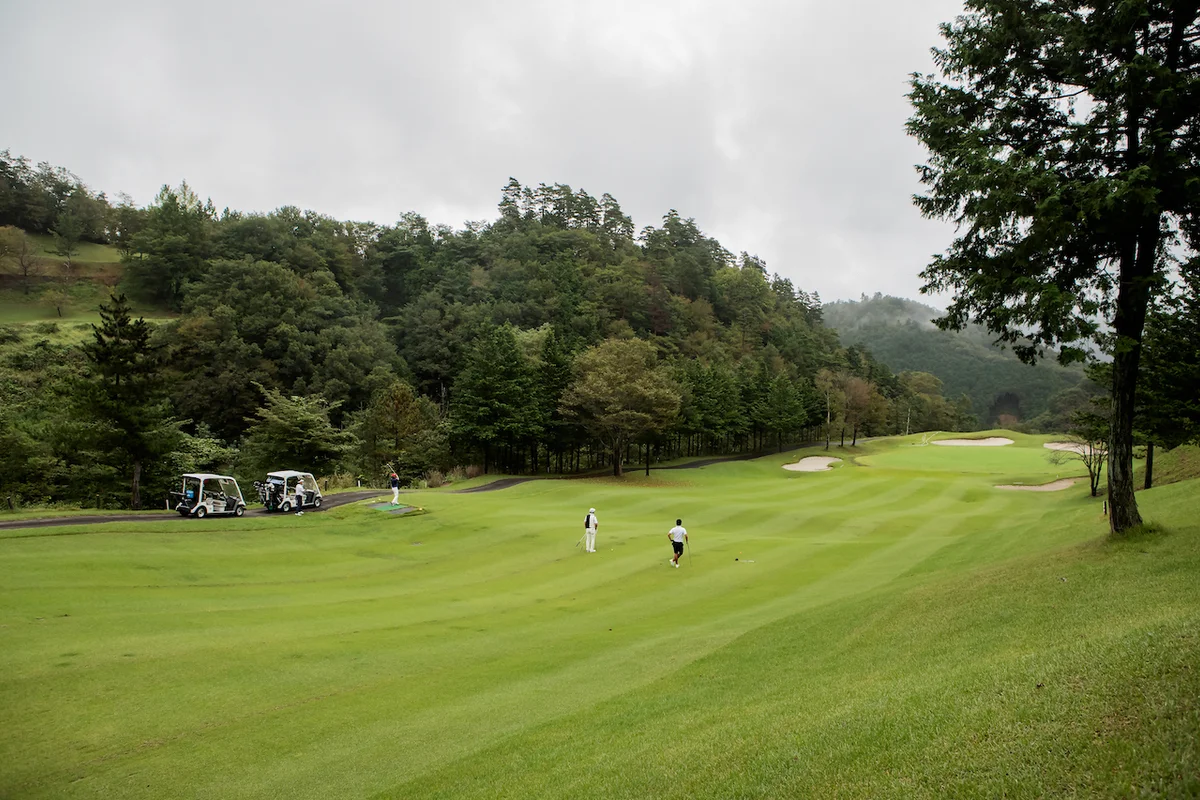 Golfers on course with trees