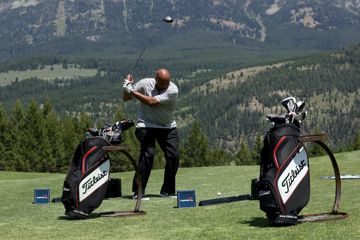 Charles Barkley swings on the driving range