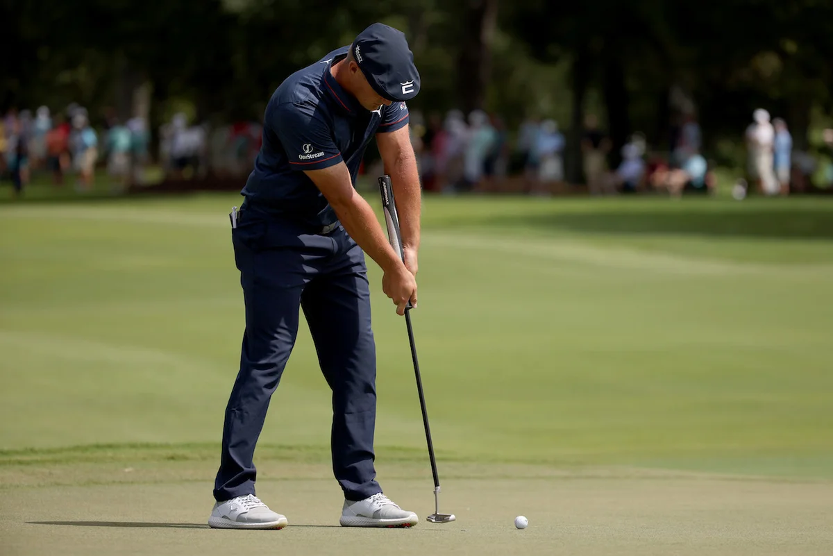 Bryson DeChambeau locking arms
