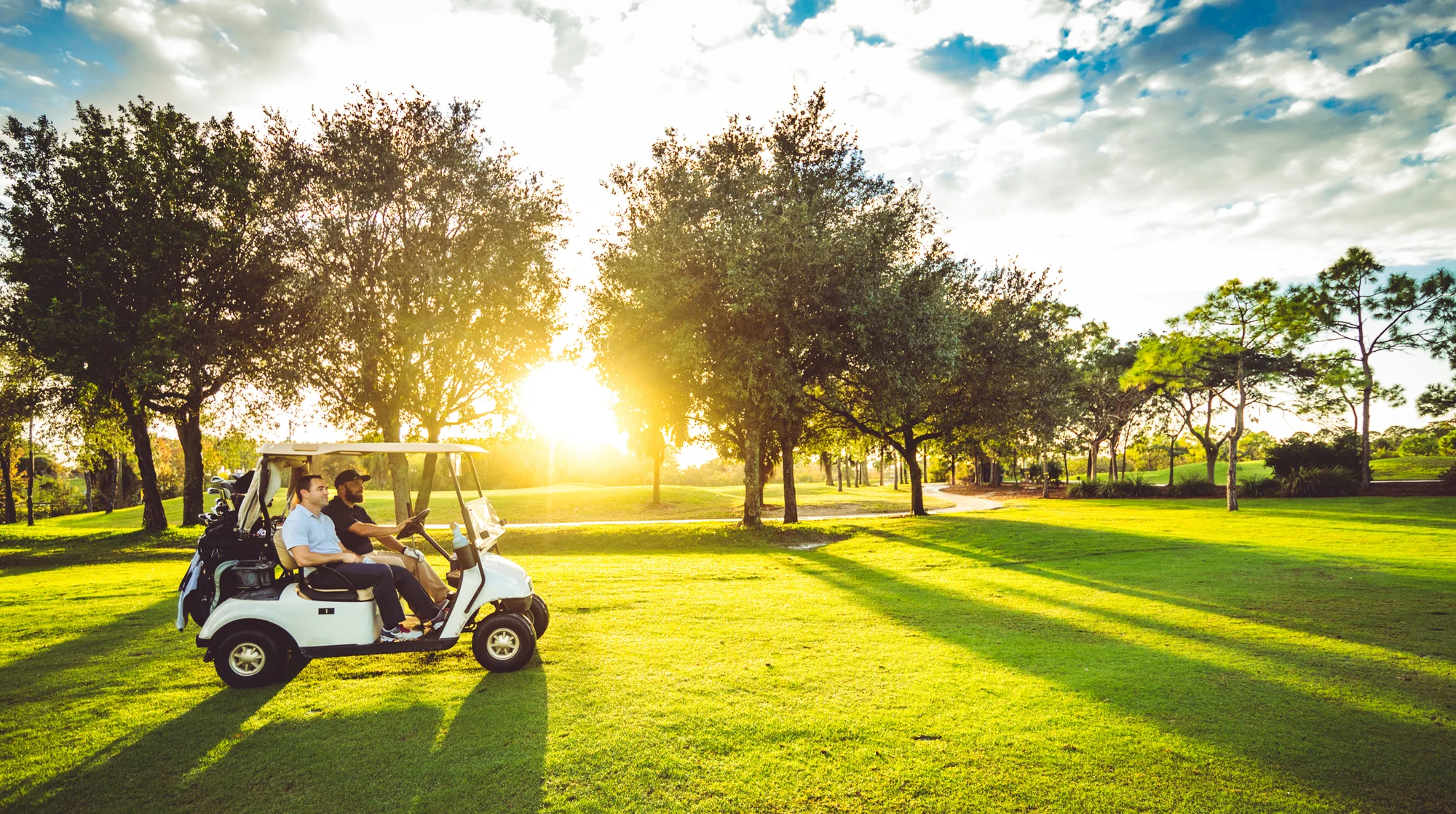 Two golfers riding a golf cart